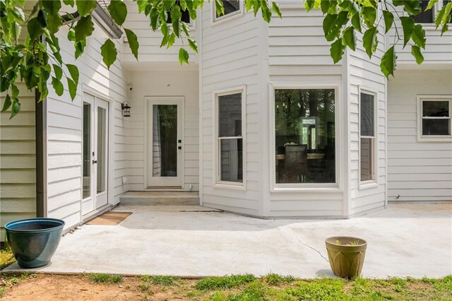 view of exterior entry featuring a patio area