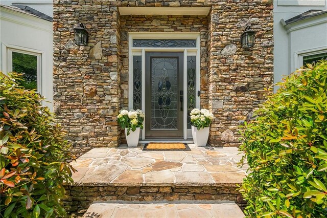 property entrance featuring stone siding