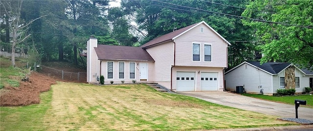 849 Cadet Ct NW, Lilburn, GA 30047 - view of front of property featuring driveway, a chimney, and a garage