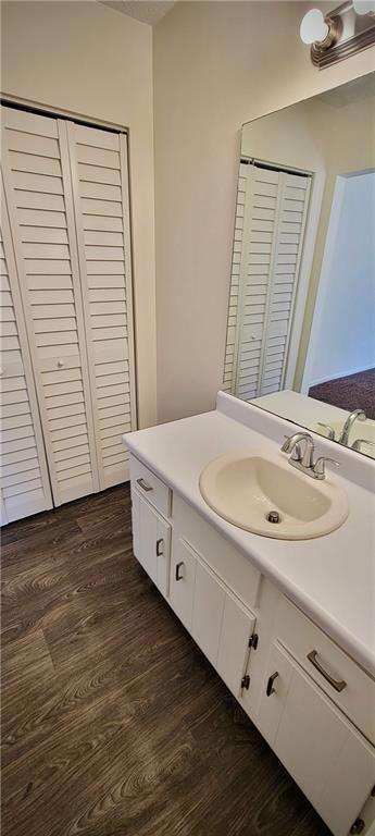 849 Cadet Ct NW, Lilburn, GA 30047 - bathroom featuring baseboards, wood finished floors, and vanity