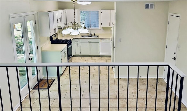 849 Cadet Ct NW, Lilburn, GA 30047 - kitchen with light countertops, a wealth of natural light, gas range, and a sink