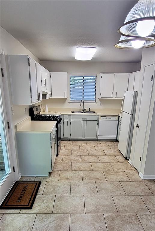 849 Cadet Ct NW, Lilburn, GA 30047 - staircase featuring tile patterned flooring and baseboards