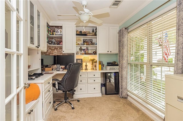 home office featuring a wealth of natural light, crown molding, ceiling fan, and light colored carpet