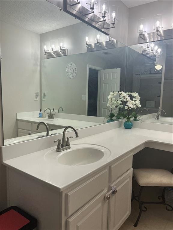 bathroom with vanity and a textured ceiling