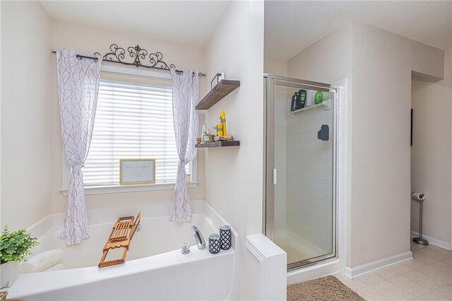 bathroom featuring tile patterned floors and separate shower and tub