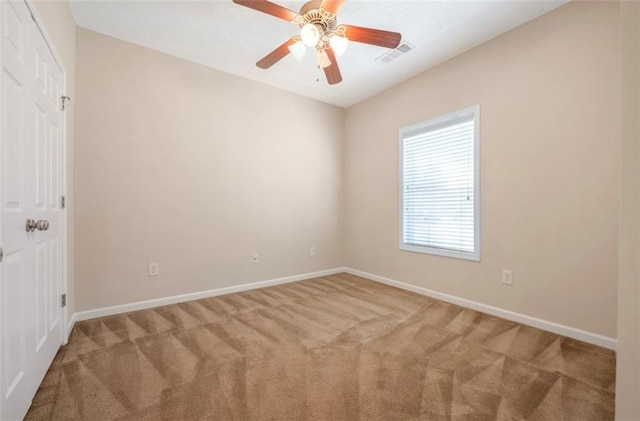 unfurnished room with light carpet and ceiling fan