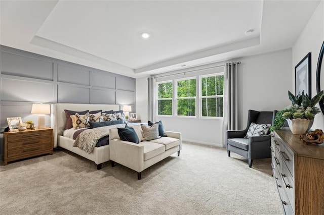 817 Dobby Way, Mcdonough, GA 30252 - bedroom featuring a raised ceiling, light carpet, and a decorative wall