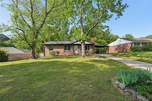 ranch-style home featuring concrete driveway and a carport