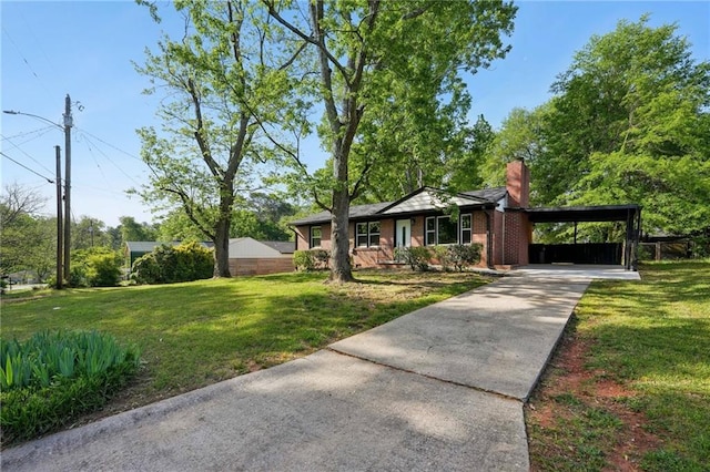 ranch-style home featuring concrete driveway, a chimney, a front lawn, and a carport