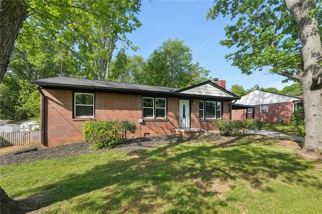 single story home featuring brick siding, a front yard, and a chimney