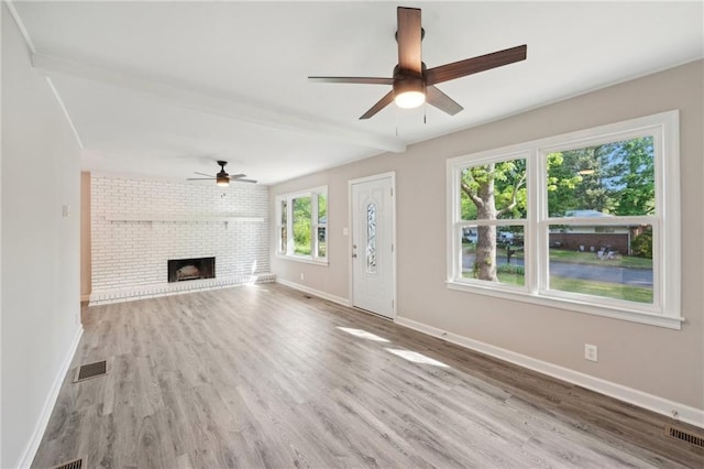 unfurnished living room featuring ceiling fan, wood finished floors, beamed ceiling, and baseboards