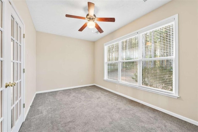 spare room with carpet floors, french doors, ceiling fan, and baseboards