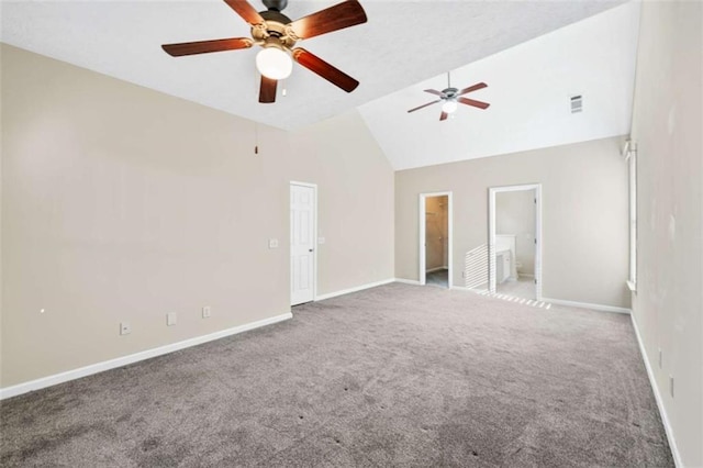 carpeted empty room featuring high vaulted ceiling, baseboards, and visible vents