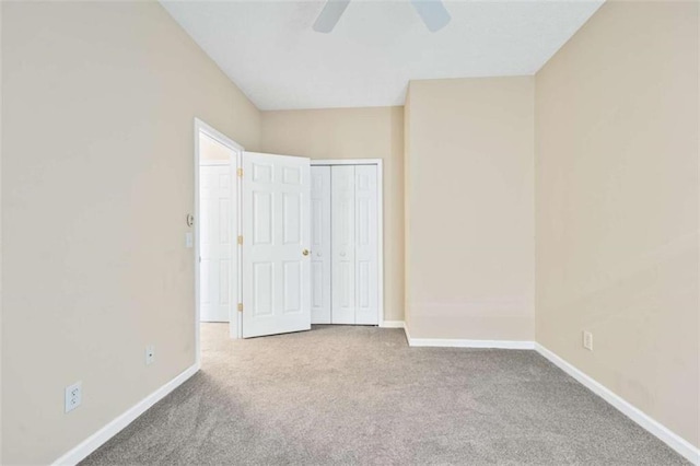 unfurnished bedroom featuring a ceiling fan, carpet, baseboards, and a closet