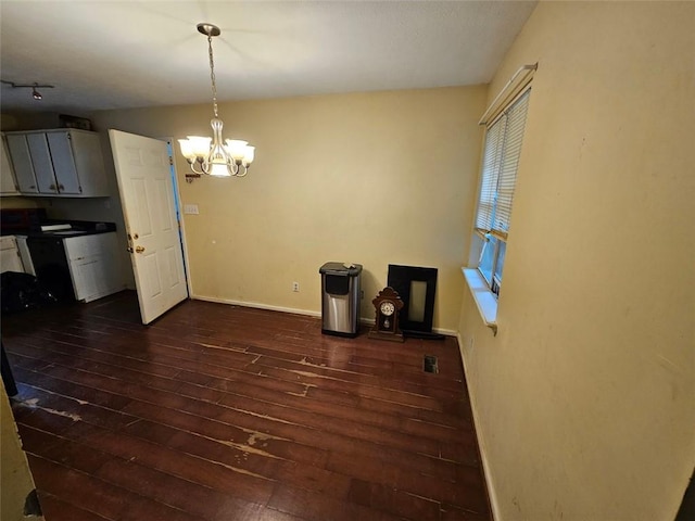 12 Lakemont Dr SE, Silver Creek, GA 30173 - unfurnished dining area with dark wood-type flooring, a chandelier, and baseboards