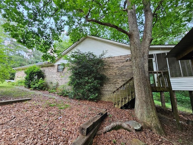 12 Lakemont Dr SE, Silver Creek, GA 30173 - view of property exterior featuring a sunroom, brick siding, and stairway
