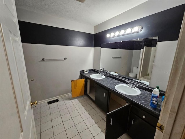 12 Lakemont Dr SE, Silver Creek, GA 30173 - bathroom featuring toilet, a textured ceiling, tile patterned floors, and double vanity
