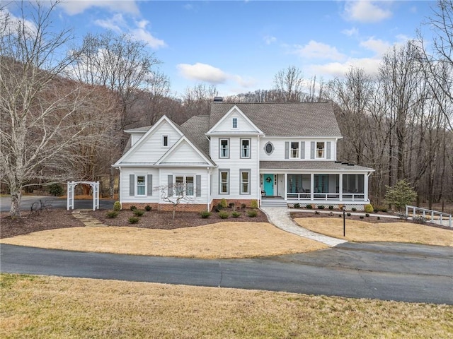 view of front of property with covered porch and a sunroom