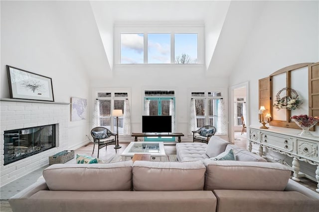 living room with a fireplace, wood-type flooring, and a high ceiling