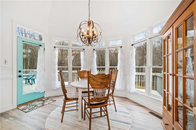 sunroom / solarium with a notable chandelier