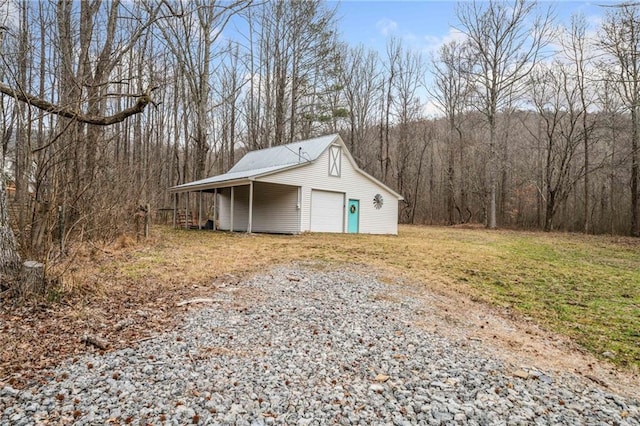 view of outdoor structure with a garage and a lawn