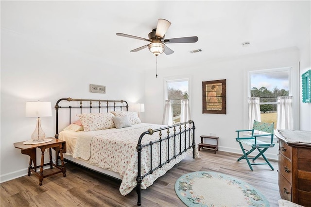 bedroom featuring hardwood / wood-style flooring and ceiling fan