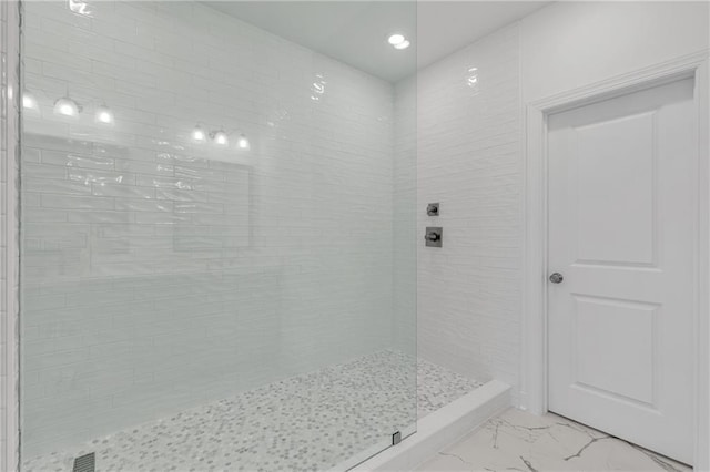 bathroom with a tile shower