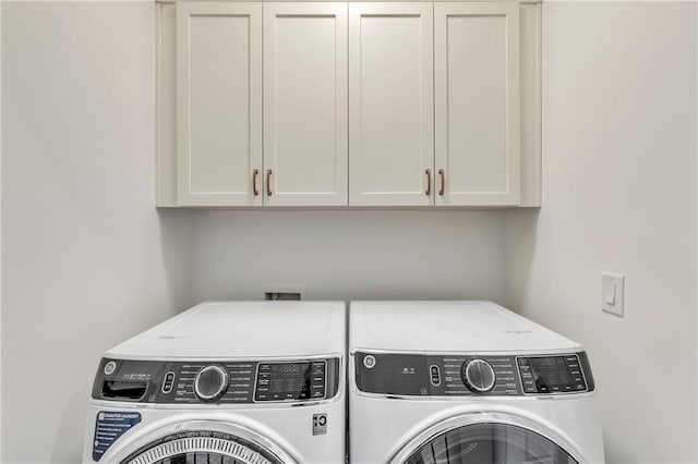 laundry area with cabinets and washer and dryer