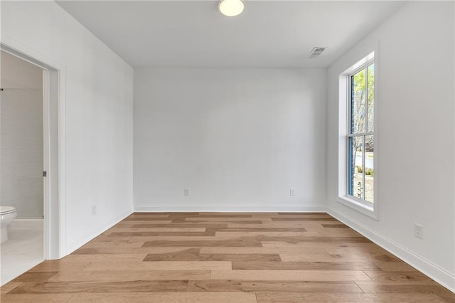 empty room with light hardwood / wood-style flooring