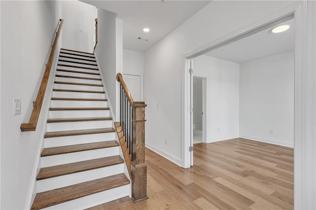 stairs with hardwood / wood-style floors