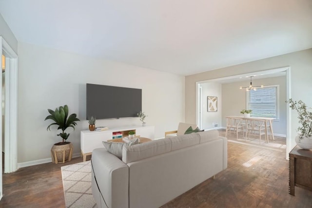 living room featuring hardwood / wood-style flooring and an inviting chandelier