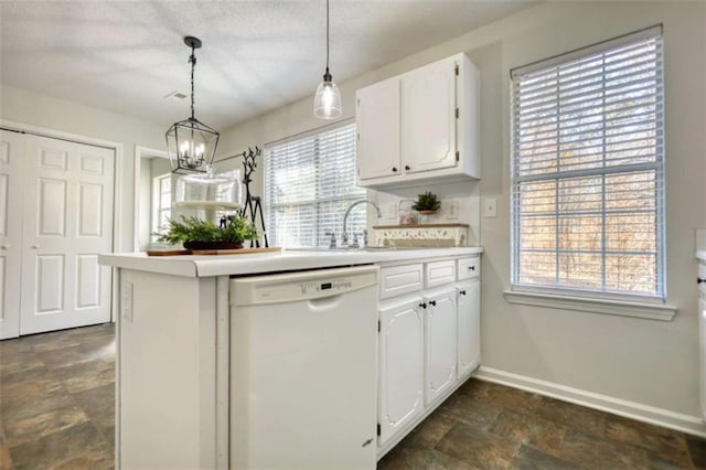 kitchen with white dishwasher, white cabinetry, and a healthy amount of sunlight