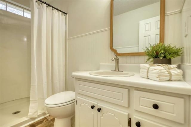 bathroom featuring curtained shower, vanity, and toilet