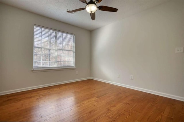 spare room featuring ceiling fan and hardwood / wood-style flooring