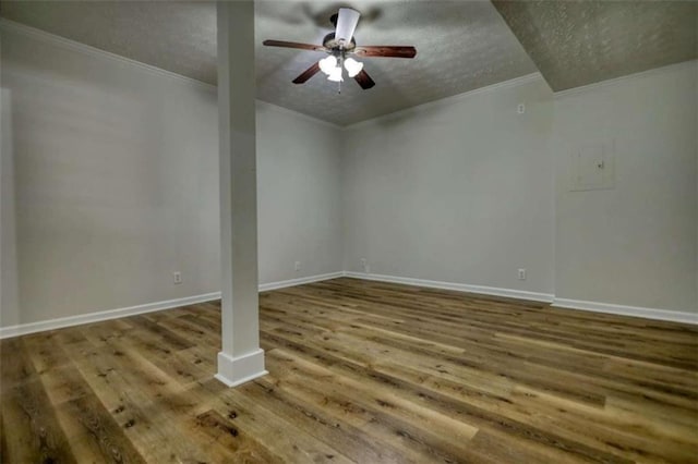 empty room with hardwood / wood-style flooring, ornamental molding, and a textured ceiling