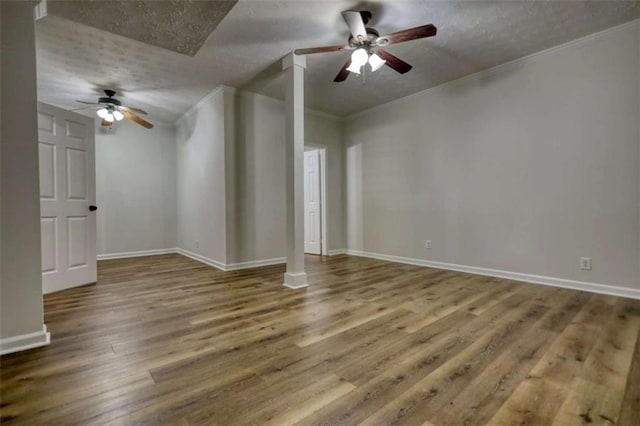 interior space featuring hardwood / wood-style floors, a textured ceiling, ceiling fan, and crown molding