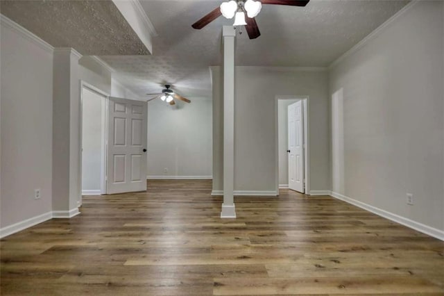 unfurnished living room featuring a textured ceiling, ceiling fan, wood-type flooring, and crown molding