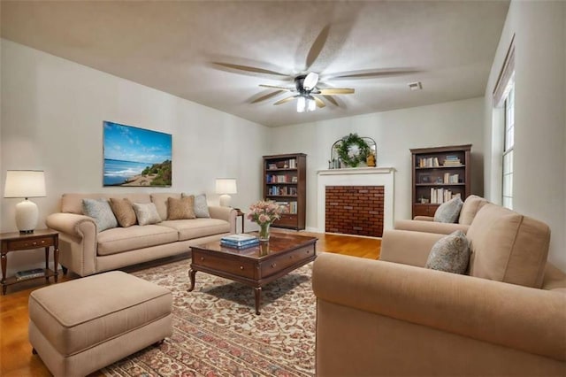 living room featuring ceiling fan and light hardwood / wood-style floors