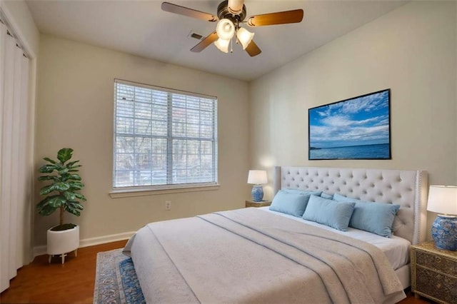 bedroom featuring hardwood / wood-style flooring, ceiling fan, and a closet