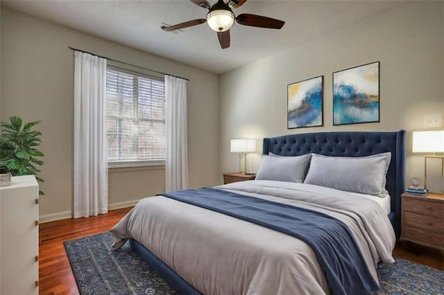 bedroom with dark hardwood / wood-style flooring and ceiling fan