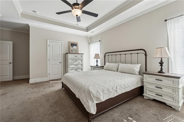 carpeted bedroom featuring a raised ceiling, crown molding, and ceiling fan