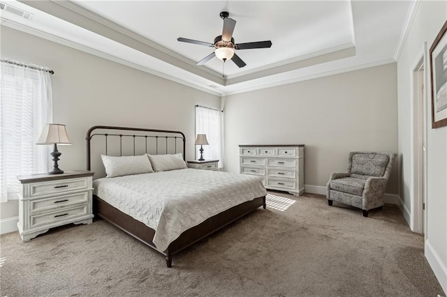 bedroom with a raised ceiling, ornamental molding, carpet floors, and ceiling fan