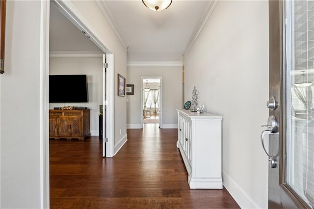 foyer entrance with crown molding and dark hardwood / wood-style floors