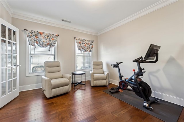 workout area with ornamental molding and dark hardwood / wood-style floors