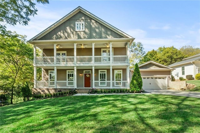 view of front of home with board and batten siding, a porch, a ceiling fan, and a front lawn