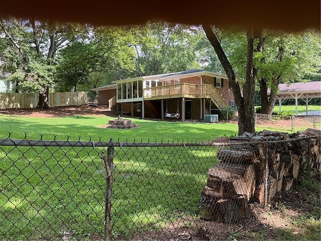 view of yard featuring a deck and central AC