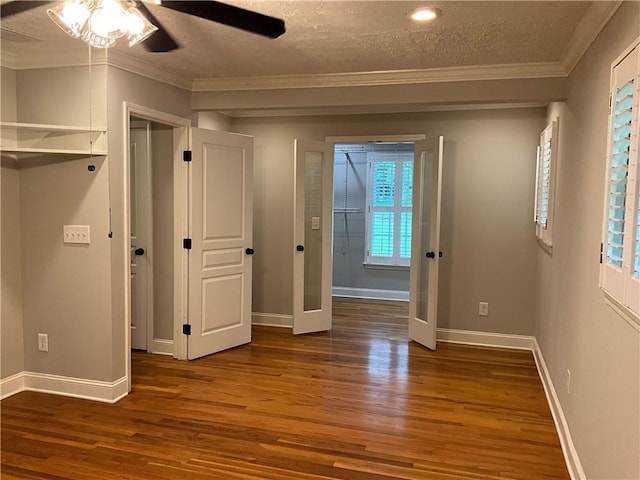 unfurnished bedroom featuring multiple windows, ceiling fan, and dark wood-type flooring