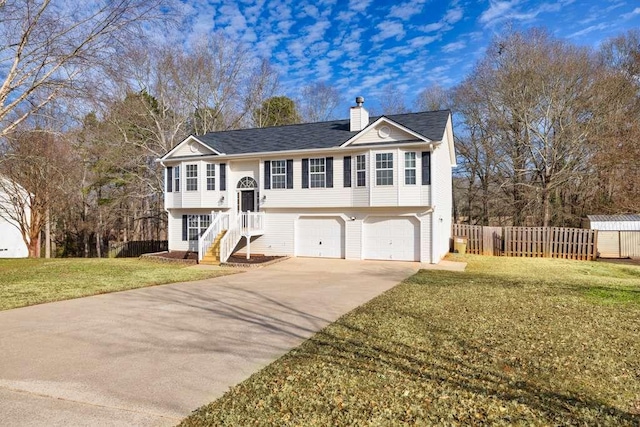 split foyer home with a front yard and a garage