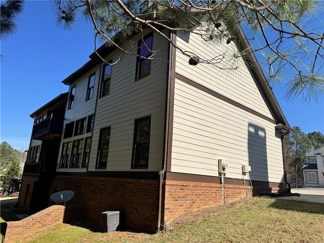 view of side of home featuring brick siding