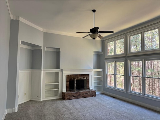 unfurnished living room featuring visible vents, a fireplace, a ceiling fan, and carpet flooring